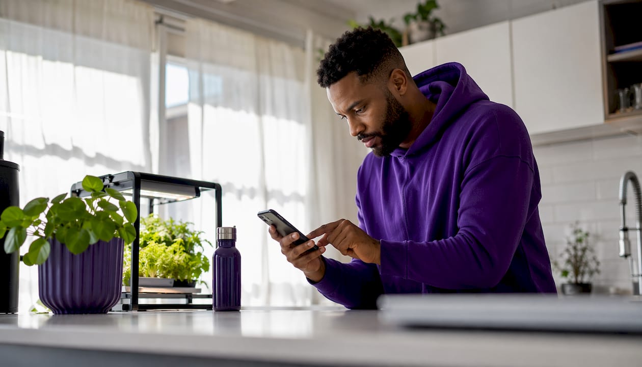 Video creator working on smartphone at home desk