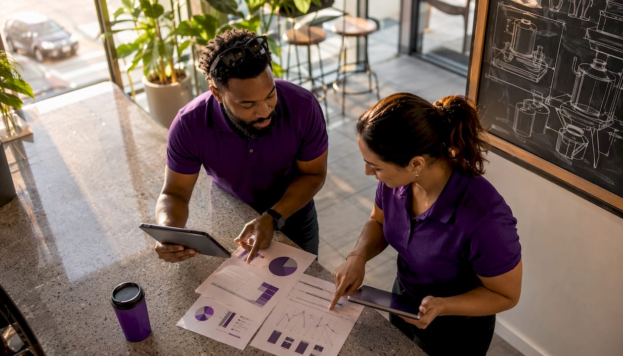 Two distributors discussing billing software tablets